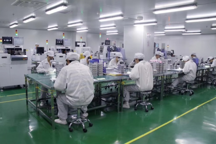 ITS Dental staff at tablet packaging worktables in the factory