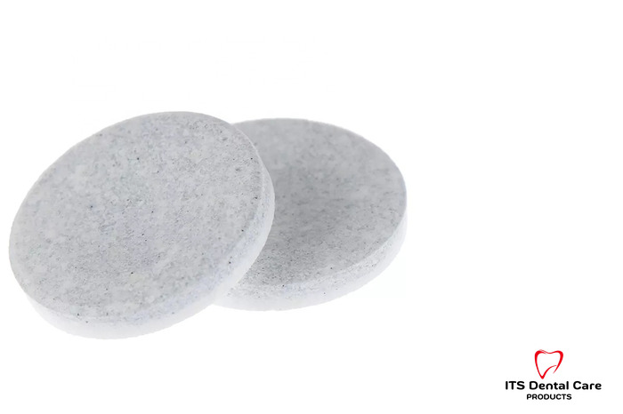 Two denture cleaning tablets on a white background